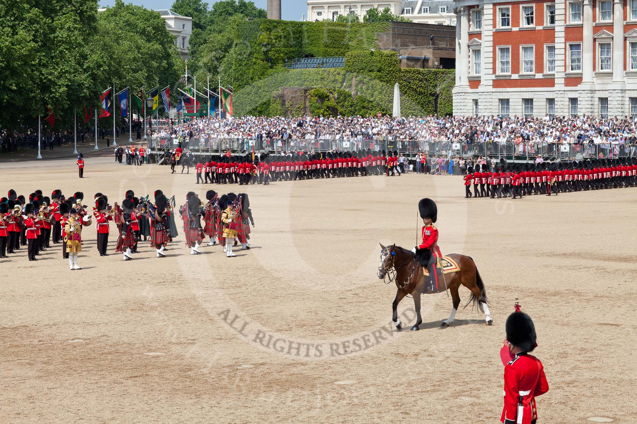 The Colonel's Review 2011: The guards are about to complete the March Past in slow time. On the left, standing in the Centre of Horse Guards Parade, the Massed Bands, in front, on horseback, the Field Officer..
Horse Guards Parade, Westminster,
London SW1,

United Kingdom,
on 04 June 2011 at 11:46, image #217