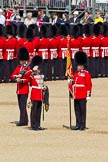 The Colonel's Review 2011: The Colour is uncased. Colour Sergeant Chris Millin is holding the flag, whilst the Duty Drummer, holding the colour case, salutes the Colour. Behind the drummer,  one of the two sentries..
Horse Guards Parade, Westminster,
London SW1,

United Kingdom,
on 04 June 2011 at 10:34, image #48