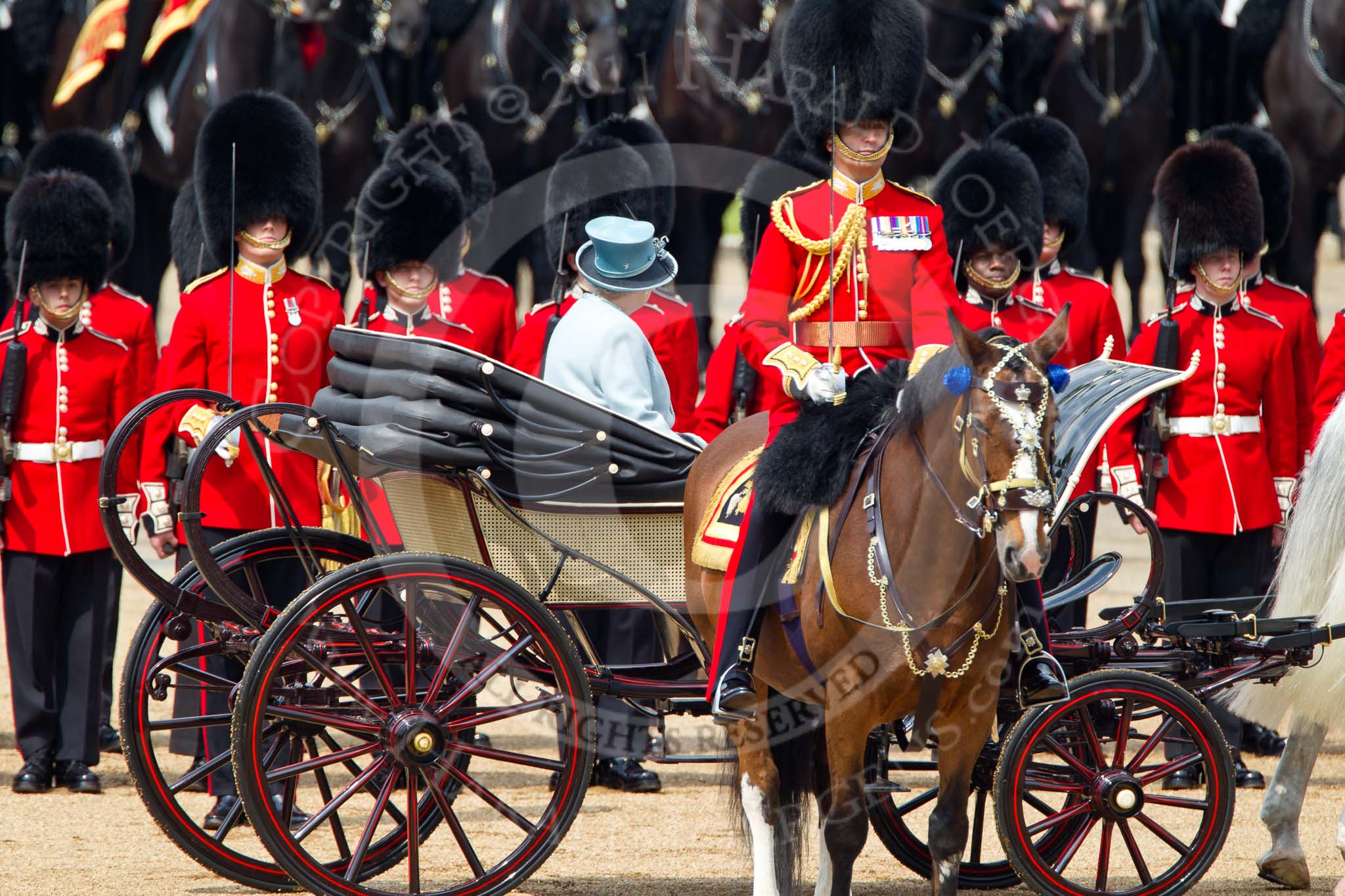 Trooping the Colour 2011: HM The Queen, in the ivory mounted phaeton, during the Inspection of the Line. In the foreground the Field Officer of the parade, Lieuteant Colonel Lincoln P M Jopp, Scots Guards..
Horse Guards Parade, Westminster,
London SW1,
Greater London,
United Kingdom,
on 11 June 2011 at 11:03, image #156