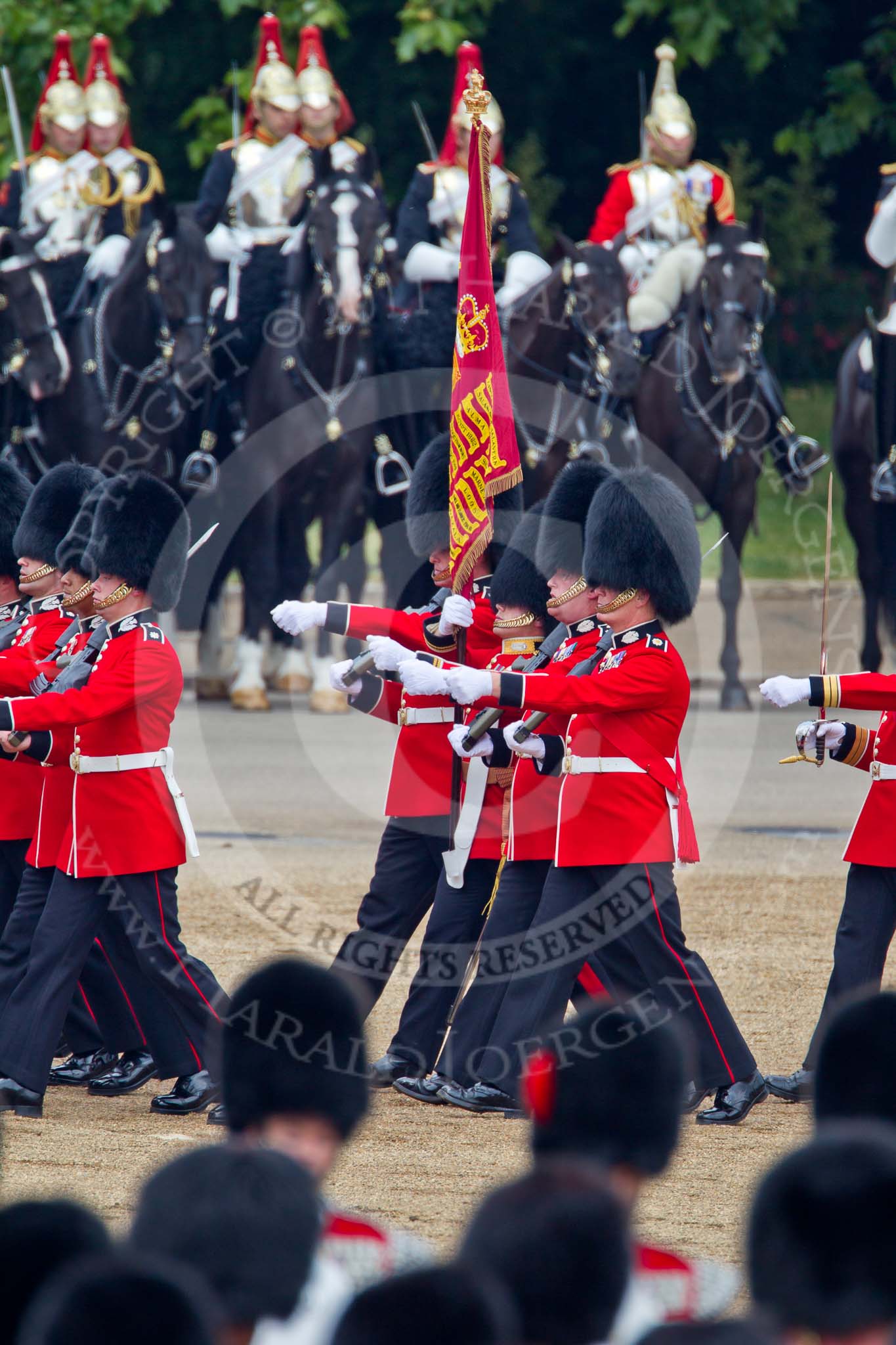 Trooping the Colour 2011: The Escort to the Colour. Carrying the flag in his white colour belt the ensign, Lieutenant Tom Ogilvy, and to his left, The Sergeant of the Ecort to the Colour, Colour Sergeant Chris Millin..
Horse Guards Parade, Westminster,
London SW1,
Greater London,
United Kingdom,
on 11 June 2011 at 11:43, image #267