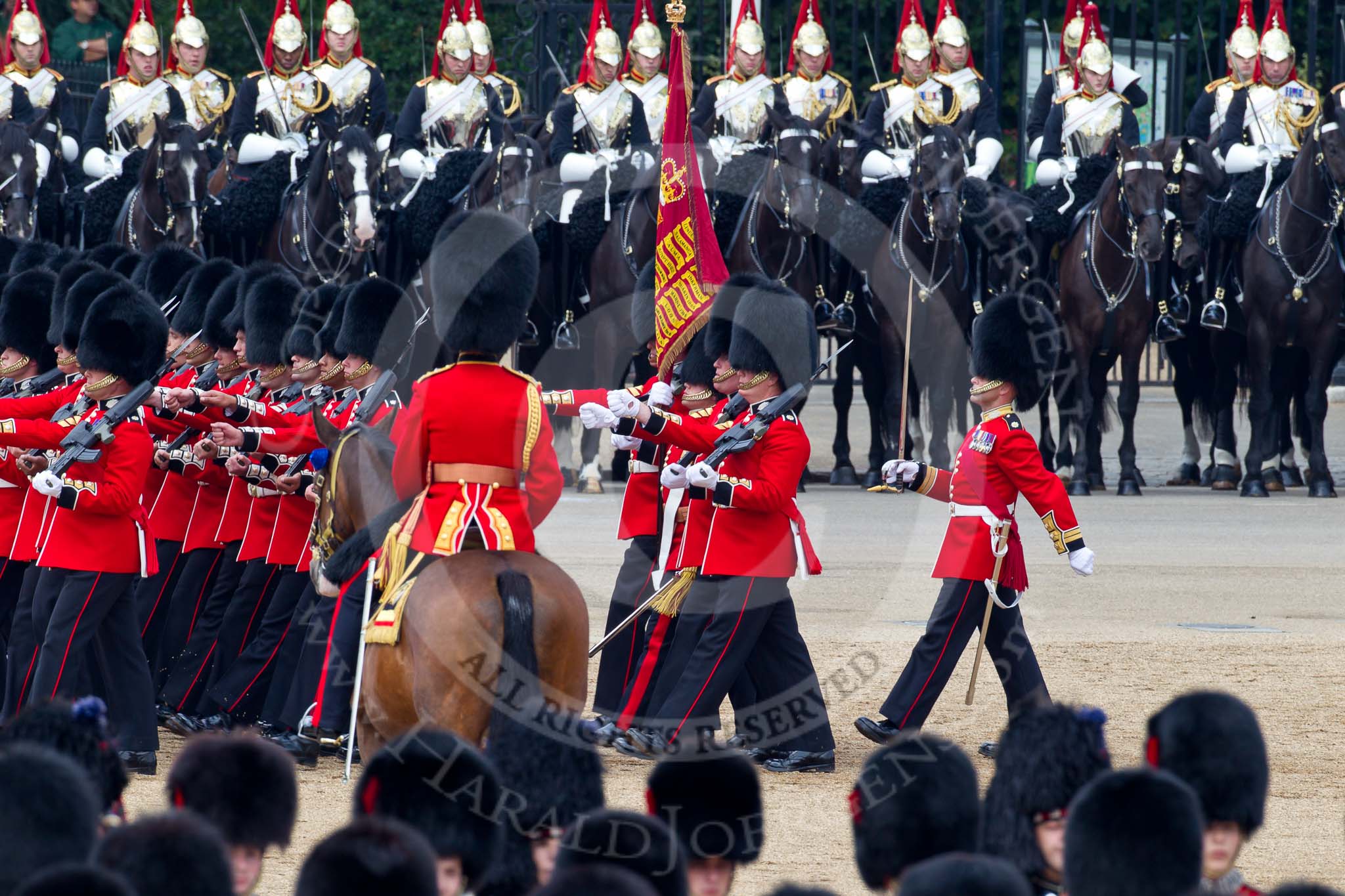 Trooping the Colour 2011: Passing the Field Officer, Lieutenant Colonel Jopp, the Escort to the Colour, 1st Battalion Scots Guards, during the March Past in slow time. Carrying the Colour the Ensign, Tom Ogilvy, to his left Colour Sergeant Chris Millin. In the background the Household Cavalry, here the Blues and Royals..
Horse Guards Parade, Westminster,
London SW1,
Greater London,
United Kingdom,
on 11 June 2011 at 11:50, image #301