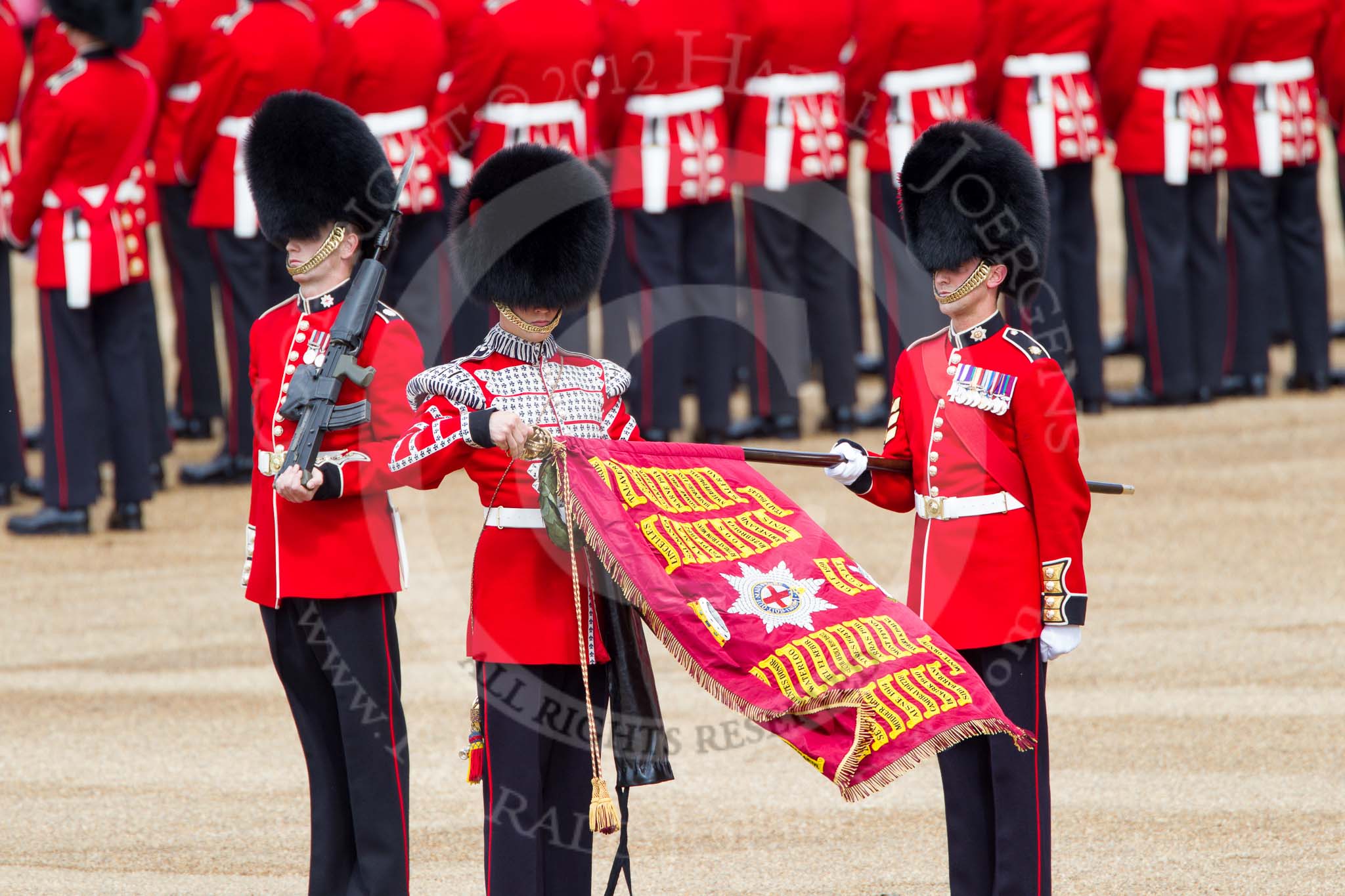 Trooping the Colour 2012: The uncasing the of Colour. With Colour Sergeant Paul Baines MC holding the flag, the Duty Drummer has removed the colour case..
Horse Guards Parade, Westminster,
London SW1,

United Kingdom,
on 16 June 2012 at 10:32, image #79
