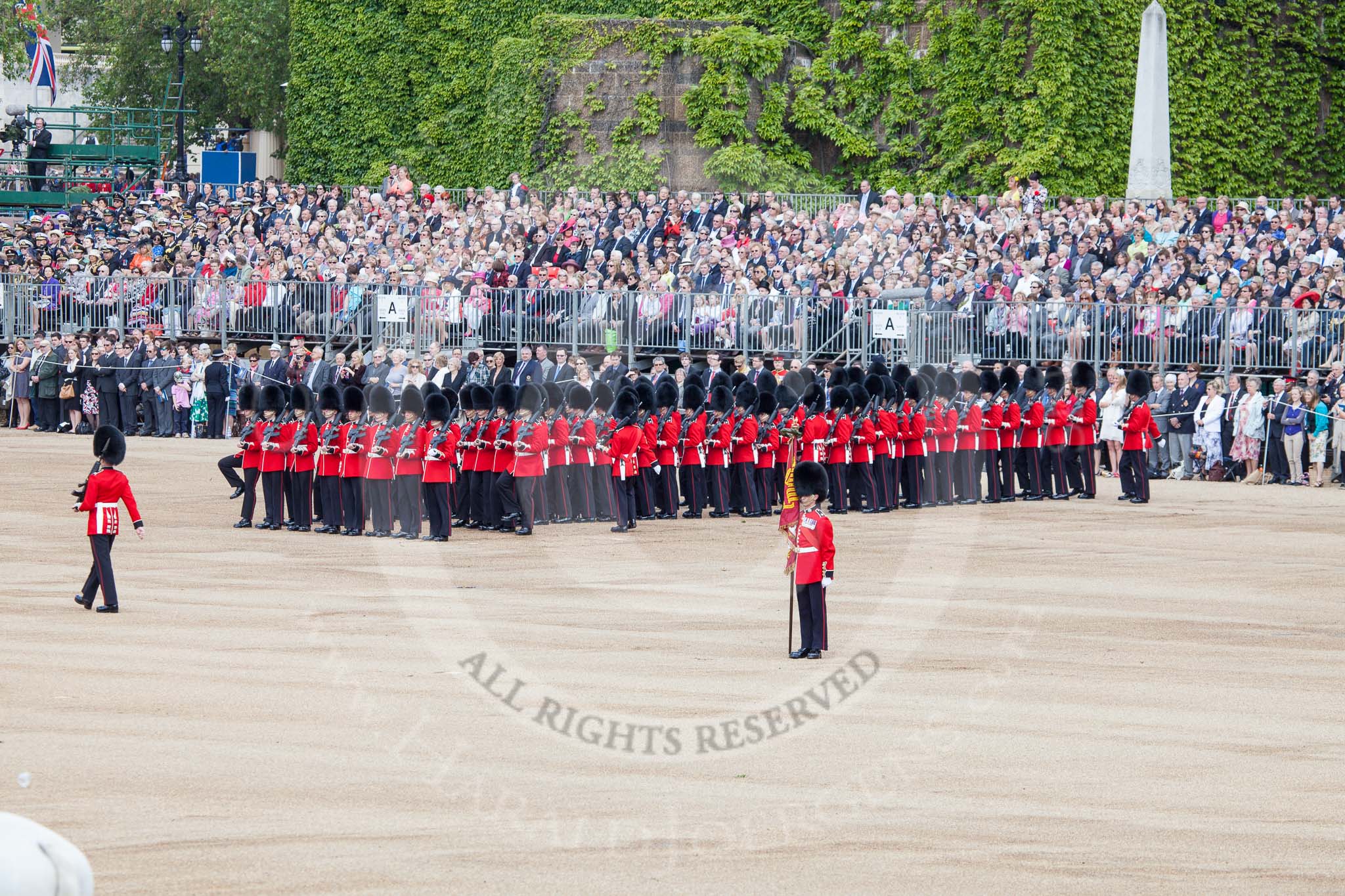 Trooping the Colour 2012: Colour Sergeant Paul Baines MC with the Regimental Colour in his place on the Eastern side of Horse Guards Parade, behind him No. 6 Guard..
Horse Guards Parade, Westminster,
London SW1,

United Kingdom,
on 16 June 2012 at 10:35, image #86
