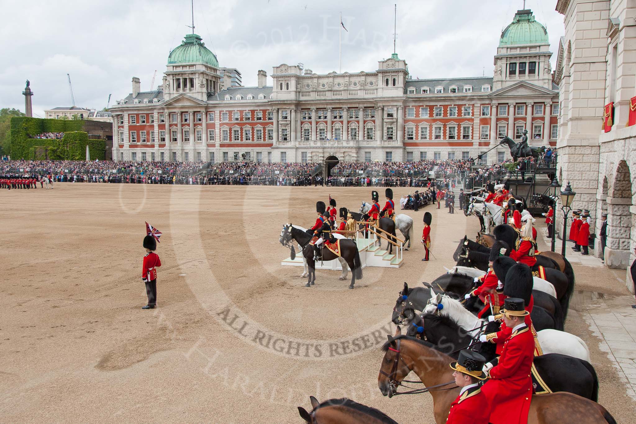 Trooping the Colour 2012: Horse Guards Parade whist the Colour is trooped. On the very right the window to the Major General's office. The spectators in front of the Ol Admirality Building are still standing. On the left of the image No. 6 Guard..
Horse Guards Parade, Westminster,
London SW1,

United Kingdom,
on 16 June 2012 at 11:28, image #357