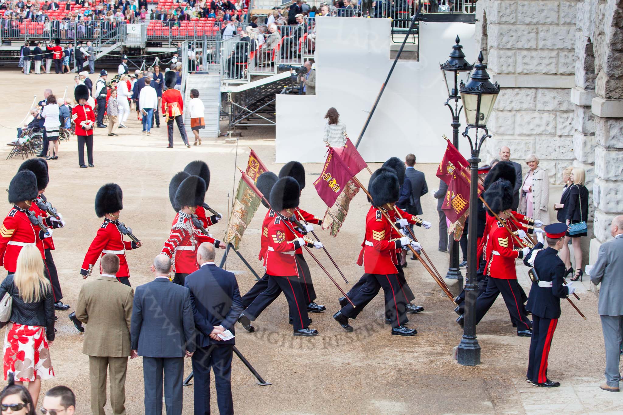 The Colonel's Review 2013: The 'Keepers of the Ground', guardsmen bearing marker flags for their respective regiments, disappearing under Horse Guards Arch, they will return later to mark the positions for their regiments..
Horse Guards Parade, Westminster,
London SW1,

United Kingdom,
on 08 June 2013 at 09:54, image #31