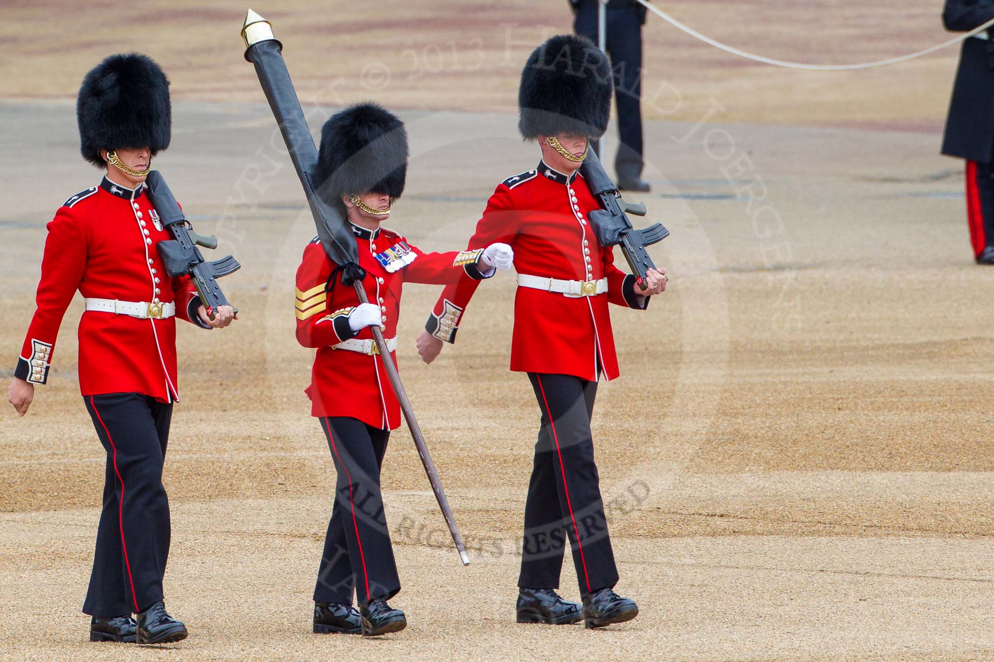 Major General's Review 2013: Colour Sergeant Robert J Heath, carrying the Colour and two sentries, Guardsman Bilton and Guardsman Pervis, marching to their position on Horse Guards Parade..
Horse Guards Parade, Westminster,
London SW1,

United Kingdom,
on 01 June 2013 at 10:31, image #114