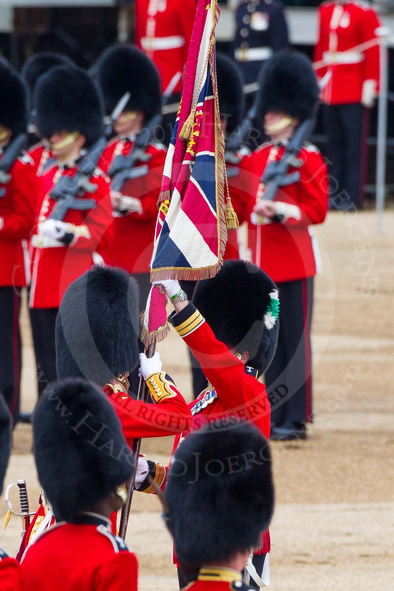 Major General's Review 2013: The Ensign, Second Lieutenant Joel Dinwiddle, takes posession of the Colour from the Regimental Sergeant Major, WO1 Martin Topps, Welsh Guards..
Horse Guards Parade, Westminster,
London SW1,

United Kingdom,
on 01 June 2013 at 11:19, image #402