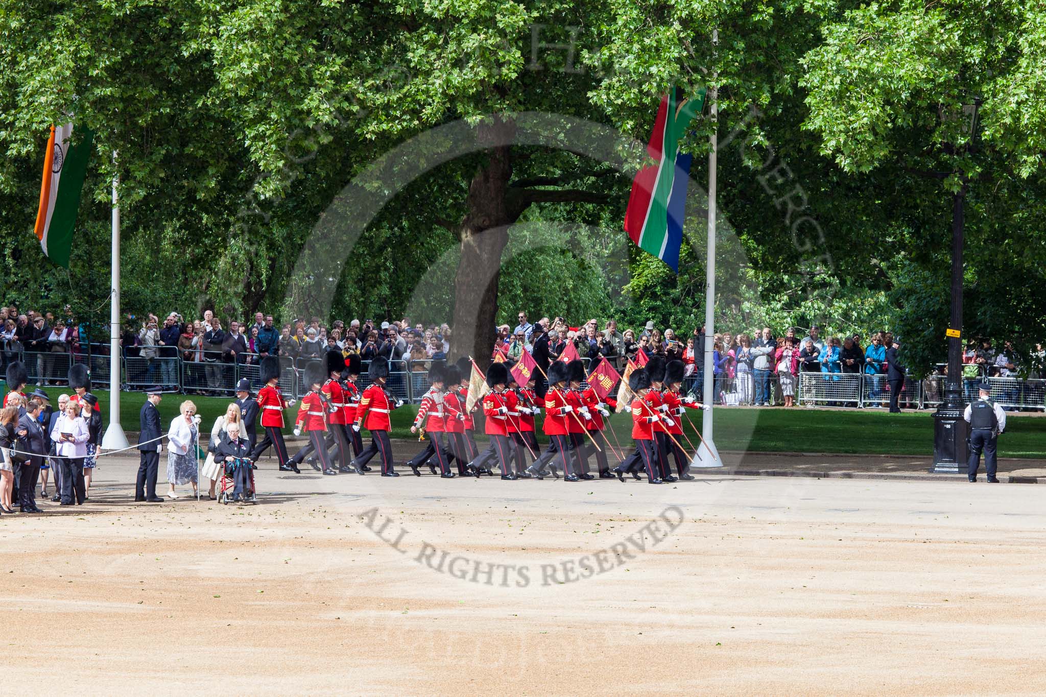 Trooping the Colour 2013: The 'Keepers of the Ground', guardsmen bearing marker flags for their respective regiments, marching on Horse Guards Road along St James's Park. Image #22, 15 June 2013 09:52 Horse Guards Parade, London, UK