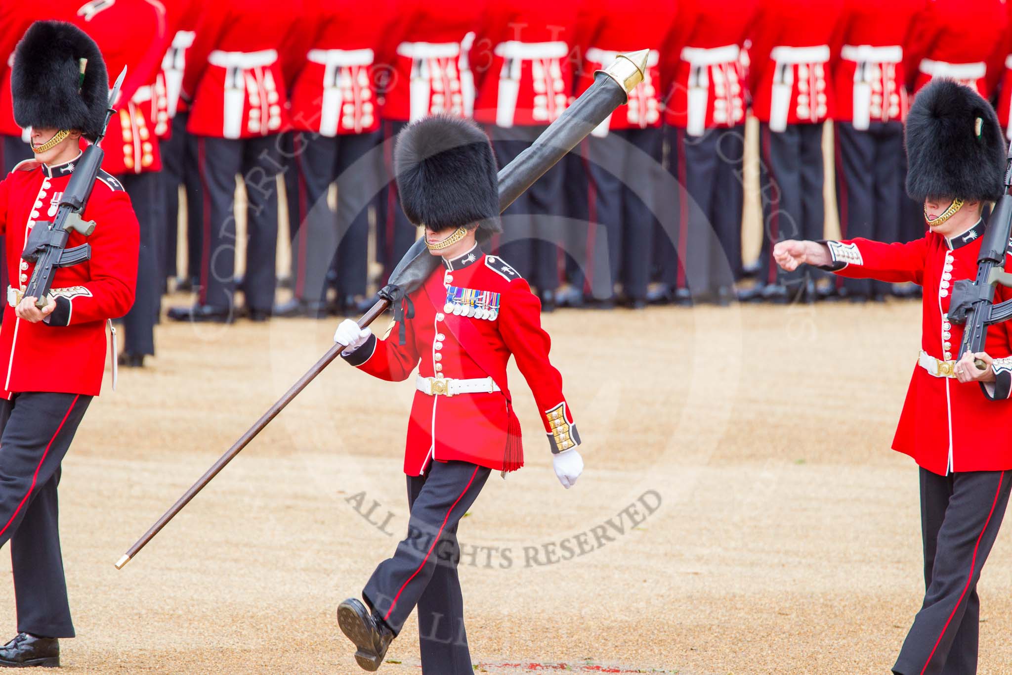 Trooping the Colour 2013: The Colour Party has reached their position on Horse Guards Parade - Colour Sergeant R J Heath, Welsh Guards, carrying the Colour, and the two sentries. Image #113, 15 June 2013 10:31 Horse Guards Parade, London, UK
