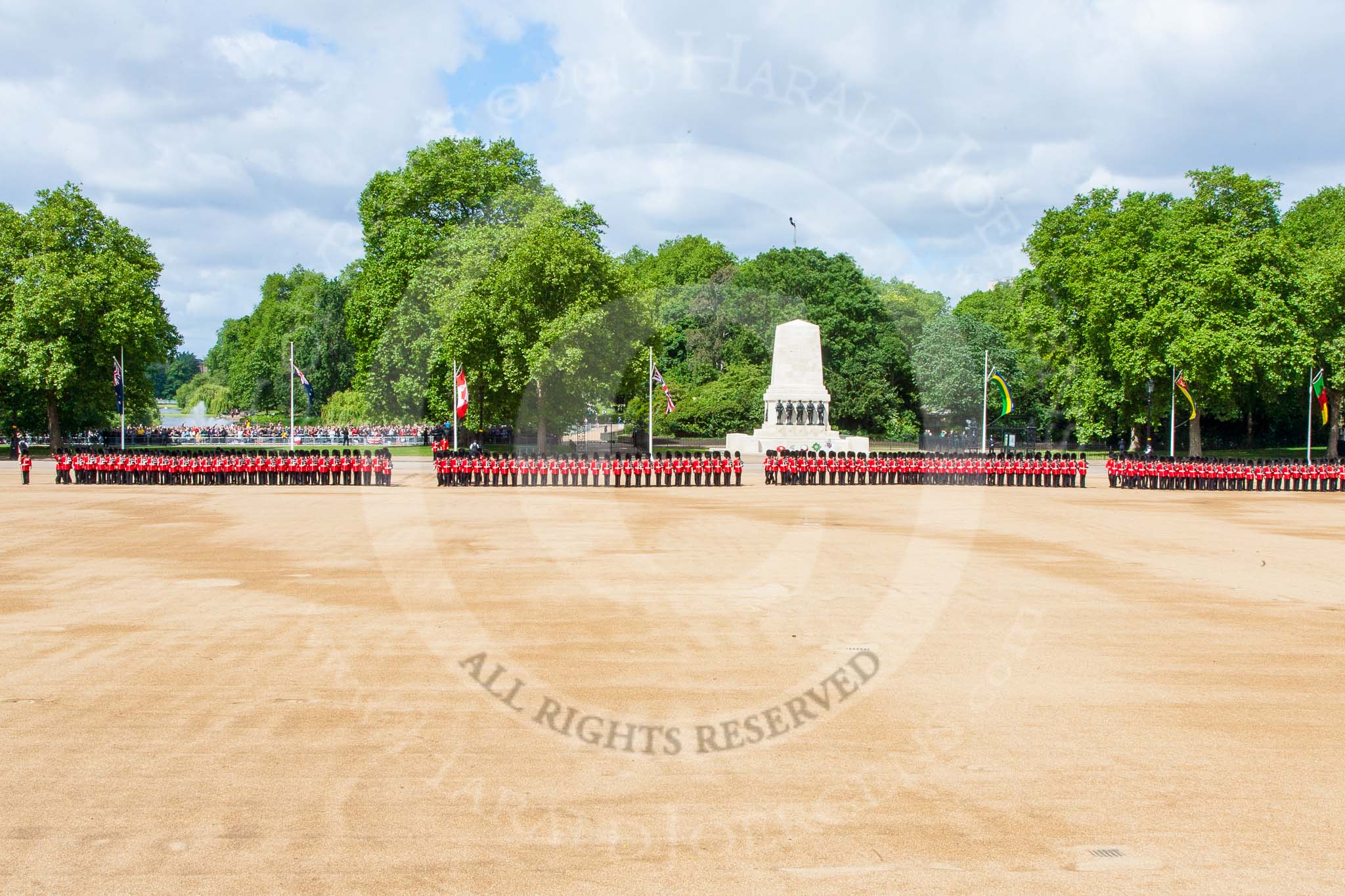 Trooping the Colour 2013: A wide angle overview of Horse Guards Parade - from left to right, No. 1 to No. 4 Guard. Behind No. 1 Guard St. James's Park Lake, behind No. 3 Guard the Guards Memorial. Image #133, 15 June 2013 10:36 Horse Guards Parade, London, UK