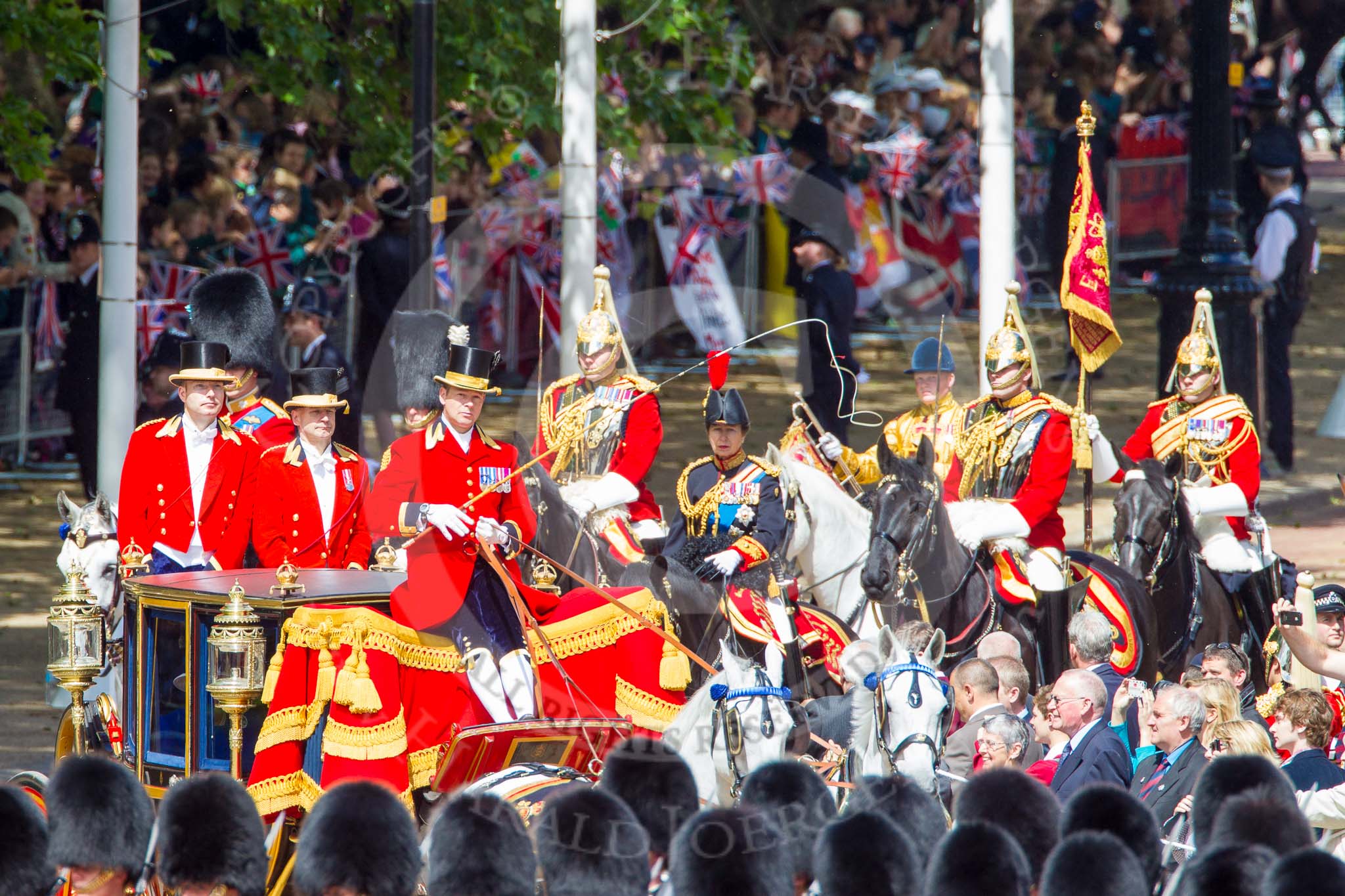 Trooping the Colour 2013: The Glass Coach carrying HM The Queen arrives at Horse Guards Parade. Behind three Royal Colonels, HRH The Duke of Cambridge, HRH The Prince of Wales, and HRH The Princess Royal. Behind them the Field Officer of the Escort, the Escort Commander, Standard Coverer, Standard Bearer, and Trumpeter. Image #253, 15 June 2013 10:58 Horse Guards Parade, London, UK