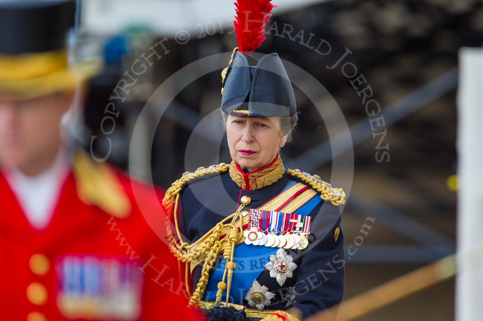 Trooping the Colour 2013: Close-up of HRH The Princess Royal, Colonel The Blues and Royals (Royal Horse Guards and 1st Dragoons), on horseback during the Inspection of the line. The Head Coachman can be seen, out of focus, in front..
Horse Guards Parade, Westminster,
London SW1,

United Kingdom,
on 15 June 2013 at 11:02, image #309