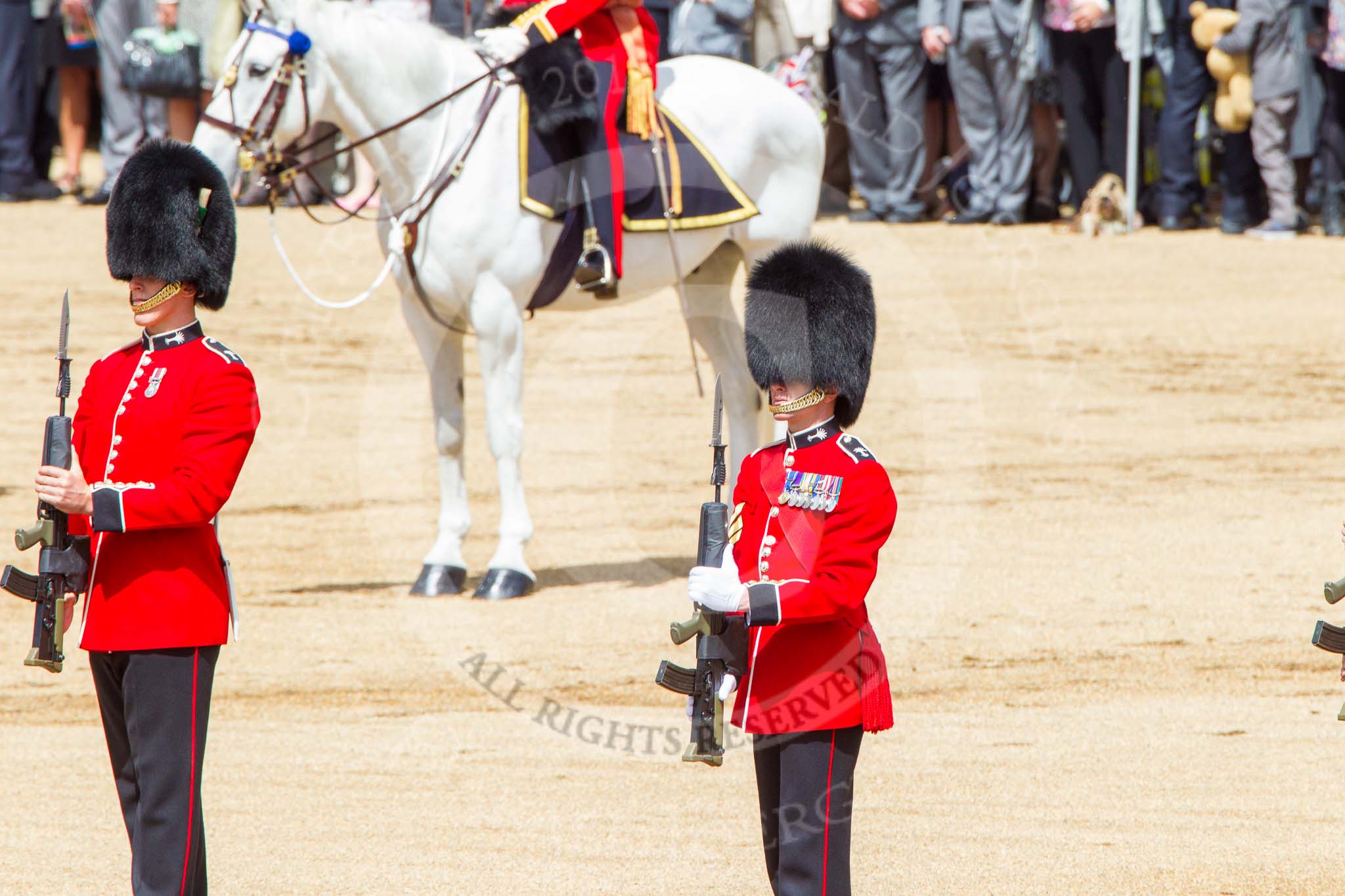 Trooping the Colour 2013: The Regimental Sergeant Major, WO1 Martin Topps, Welsh Guards, one of the two (unnamed) sentries, and the Colour Sergeant, R J Heath, Welsh Guards, presenting arms. Image #466, 15 June 2013 11:21 Horse Guards Parade, London, UK