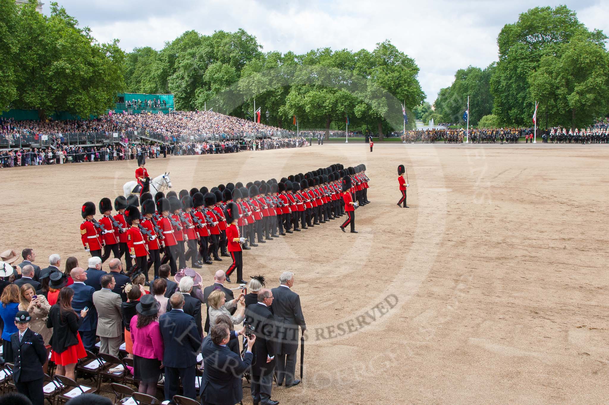 Trooping the Colour 2013: No. 6 Guard, No. 7 Company Coldstream Guards, during the March Past. In front, swords drawn, Major T P Y Radcliffe, Second Lieutenant J C Olley, and Captain C E B Starkey. Image #553, 15 June 2013 11:38 Horse Guards Parade, London, UK