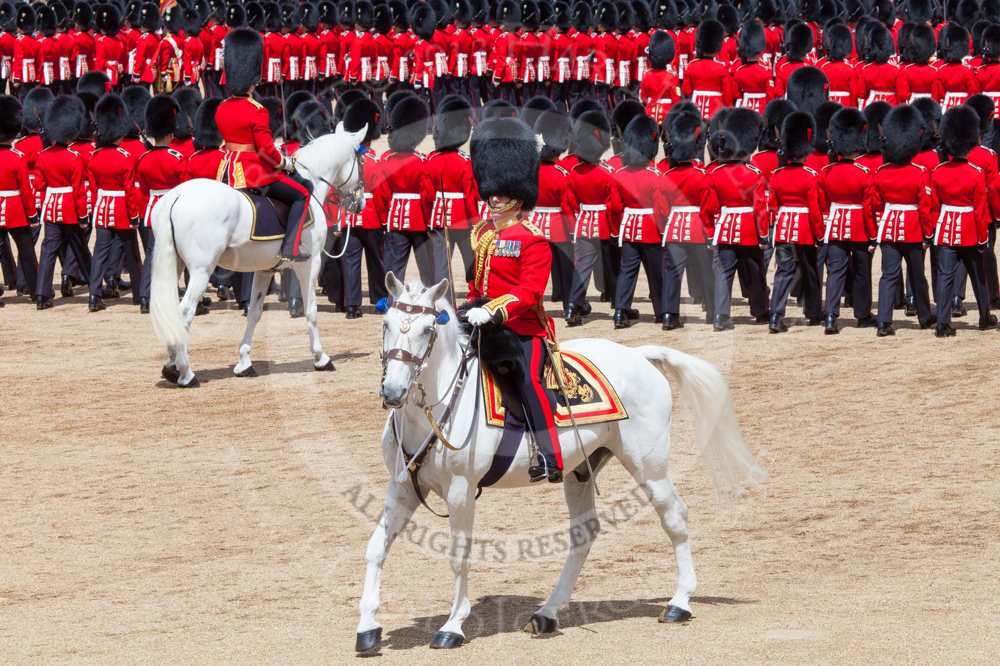 Trooping the Colour 2013: The Field Officer in Brigade Waiting, Lieutenant Colonel Dino Bossi, Welsh Guards, has left the front of the March Past to salute to Her Majesty. Seen behind him, following the guards, is the The Adjutant of the Parade, Captain C J P Davies, Welsh Guards. Image #561, 15 June 2013 11:39 Horse Guards Parade, London, UK