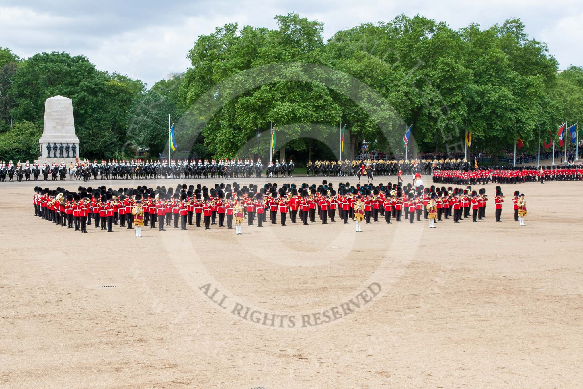 Trooping the Colour 2013: The Massed Bands, in the centre of Horse Guards Parade during the March Past, with the guards, on the very right of the image, march around them. Image #572, 15 June 2013 11:41 Horse Guards Parade, London, UK
