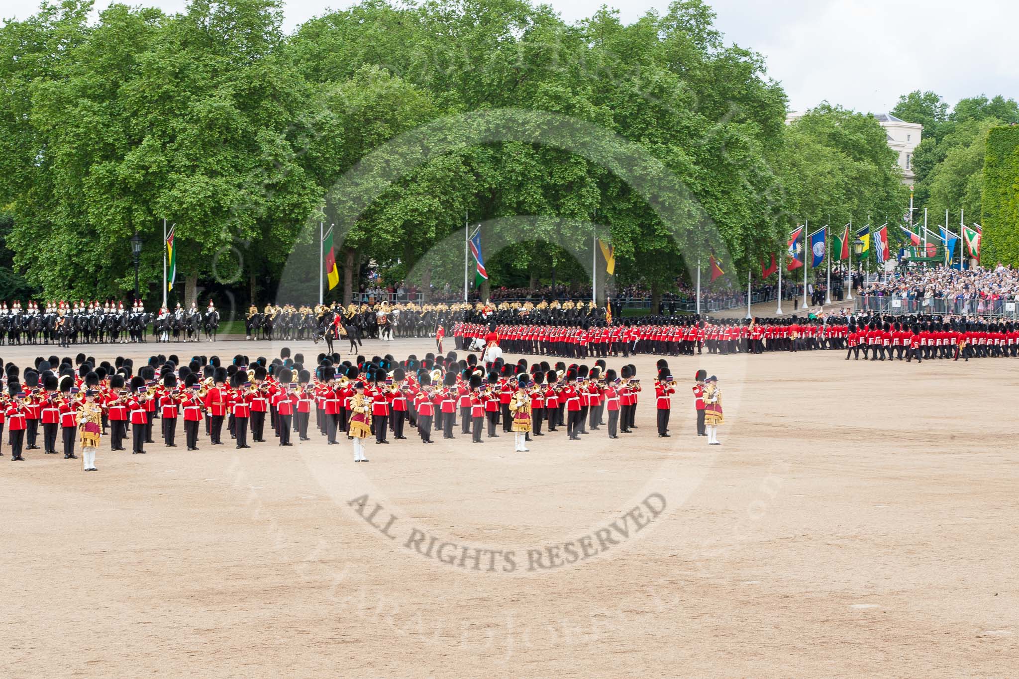 Trooping the Colour 2013: The Massed Bands, in the centre of Horse Guards Parade during the March Past, with the guards, on the very right of the image, march around them. Image #573, 15 June 2013 11:41 Horse Guards Parade, London, UK