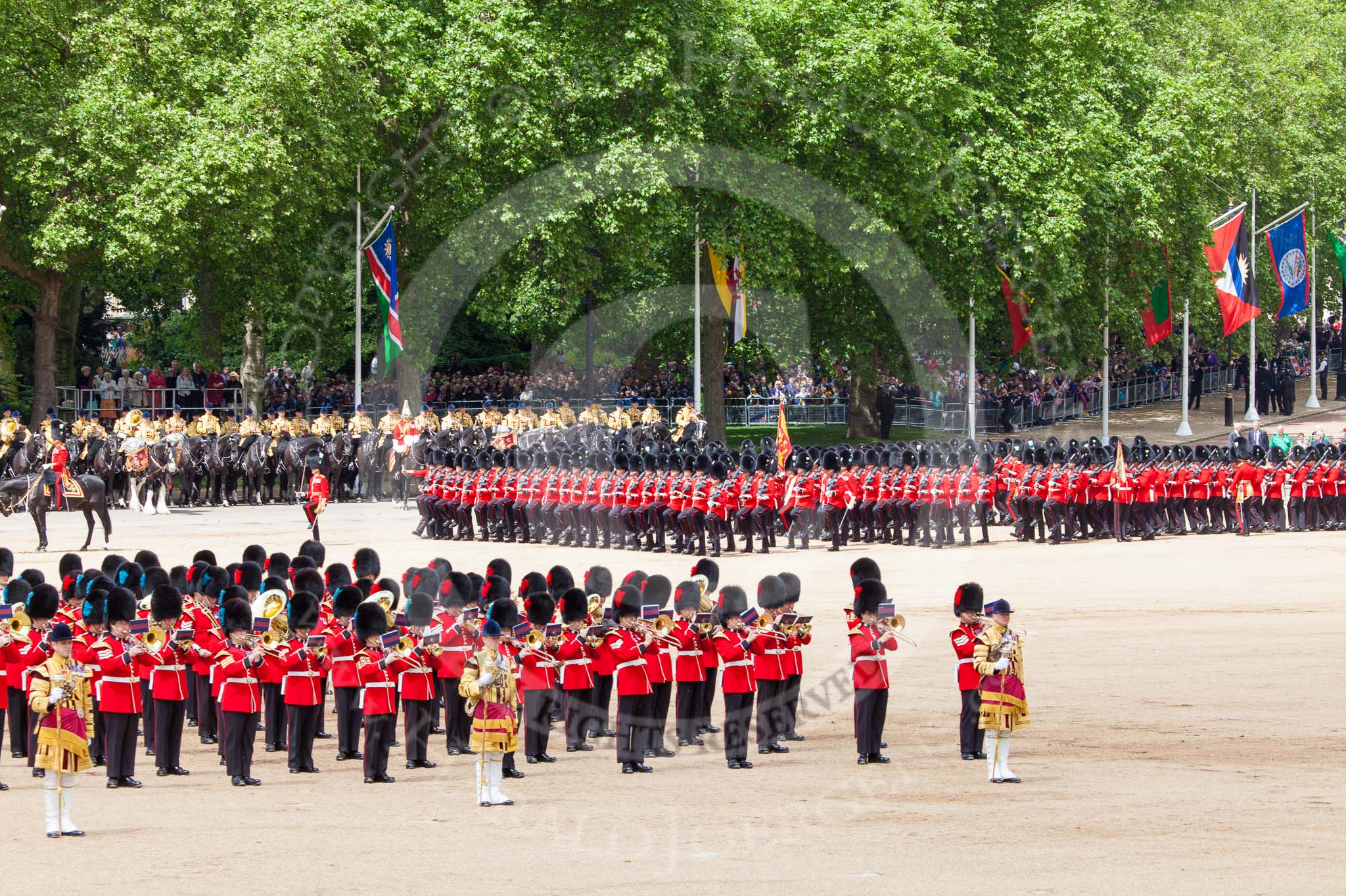 Trooping the Colour 2013: The March Past in Quick Time. The guards are marching beween the Massed Bands, in front, and the Mounted Band of the Household Cavalry behind them. Image #618, 15 June 2013 11:48 Horse Guards Parade, London, UK