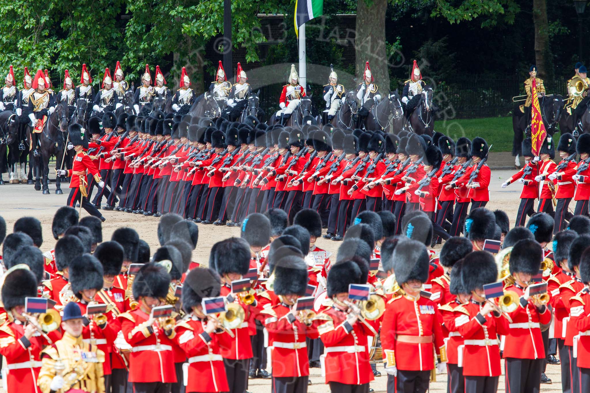Trooping the Colour 2013: The March Past in Quick Time. The guards are marching beween the Massed Bands, in front, and the Blues and Royals behind them. Image #620, 15 June 2013 11:48 Horse Guards Parade, London, UK