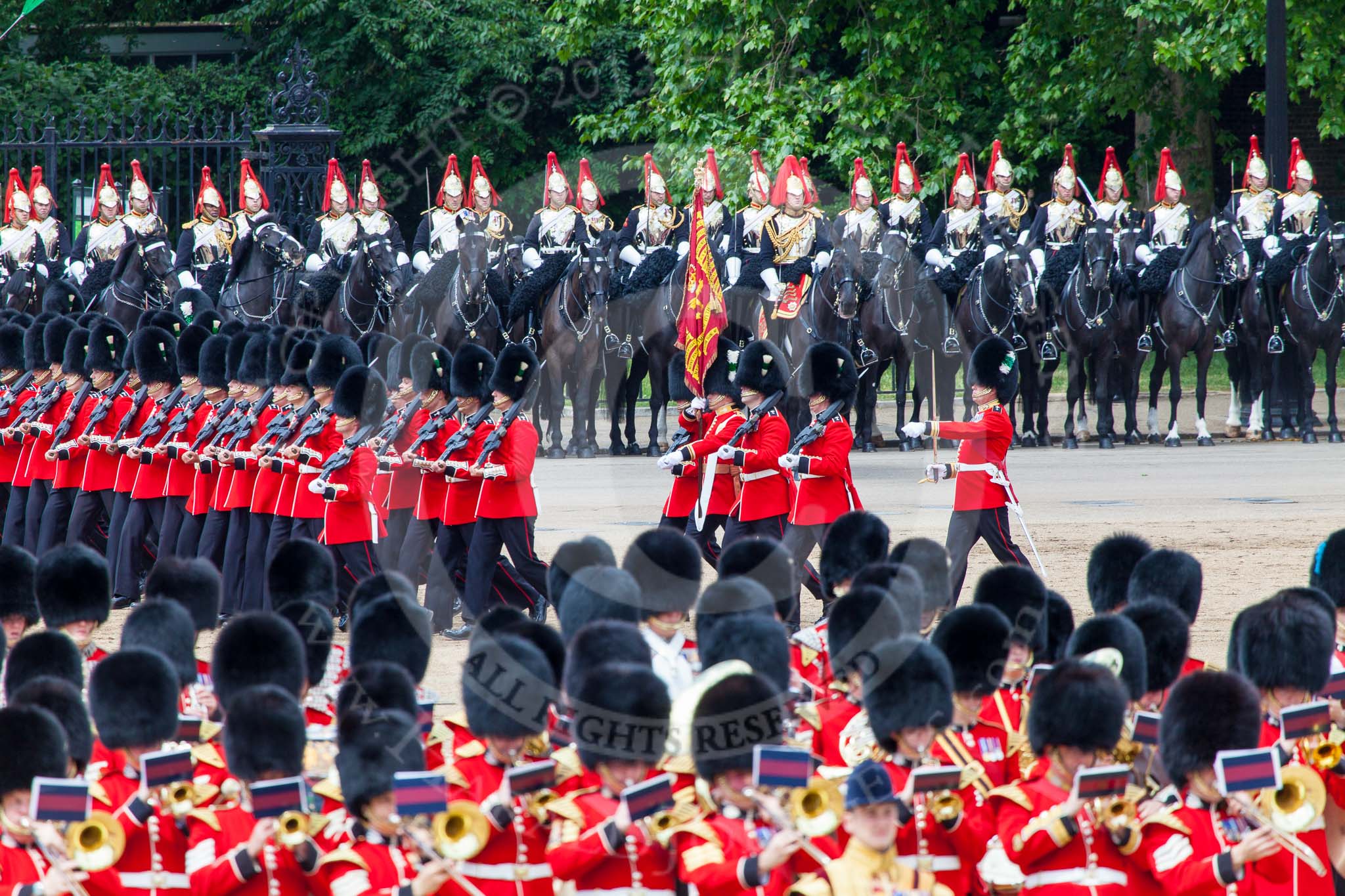 Trooping the Colour 2013: The March Past in Quick Time. The guards are marching beween the Massed Bands, in front, and the Blues and Royals behind them. The Colour Party and the Regimental Sergeant Major ar marching behind No.  Guard. Image #622, 15 June 2013 11:48 Horse Guards Parade, London, UK