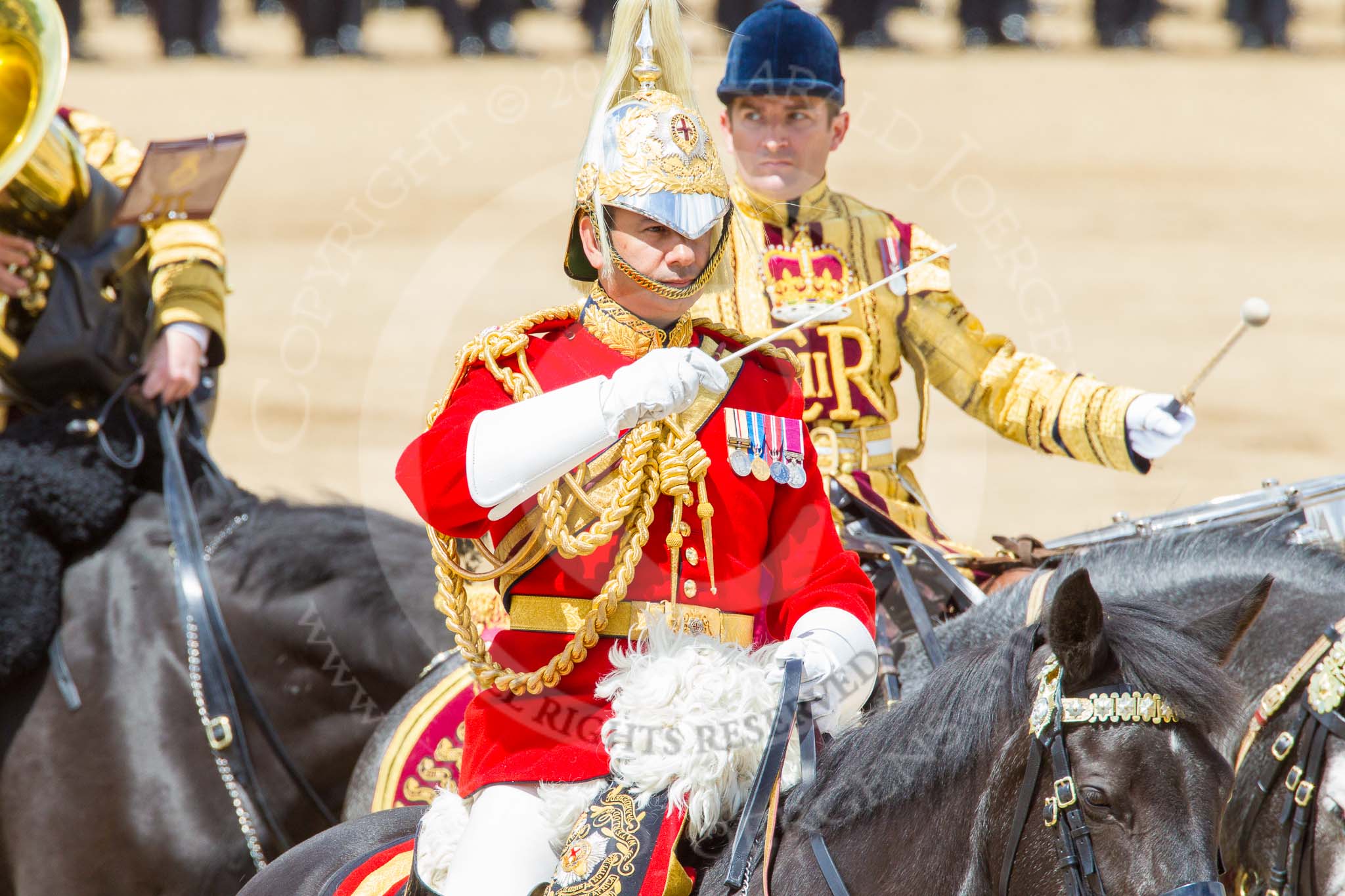 Trooping the Colour 2013: The Director of Music of the Household Cavalry, Major Paul Wilman, The Life Guards, during the Mounted Troops Ride Past. Behind him the kettle drummer from The Blues and Royals. Image #660, 15 June 2013 11:53 Horse Guards Parade, London, UK