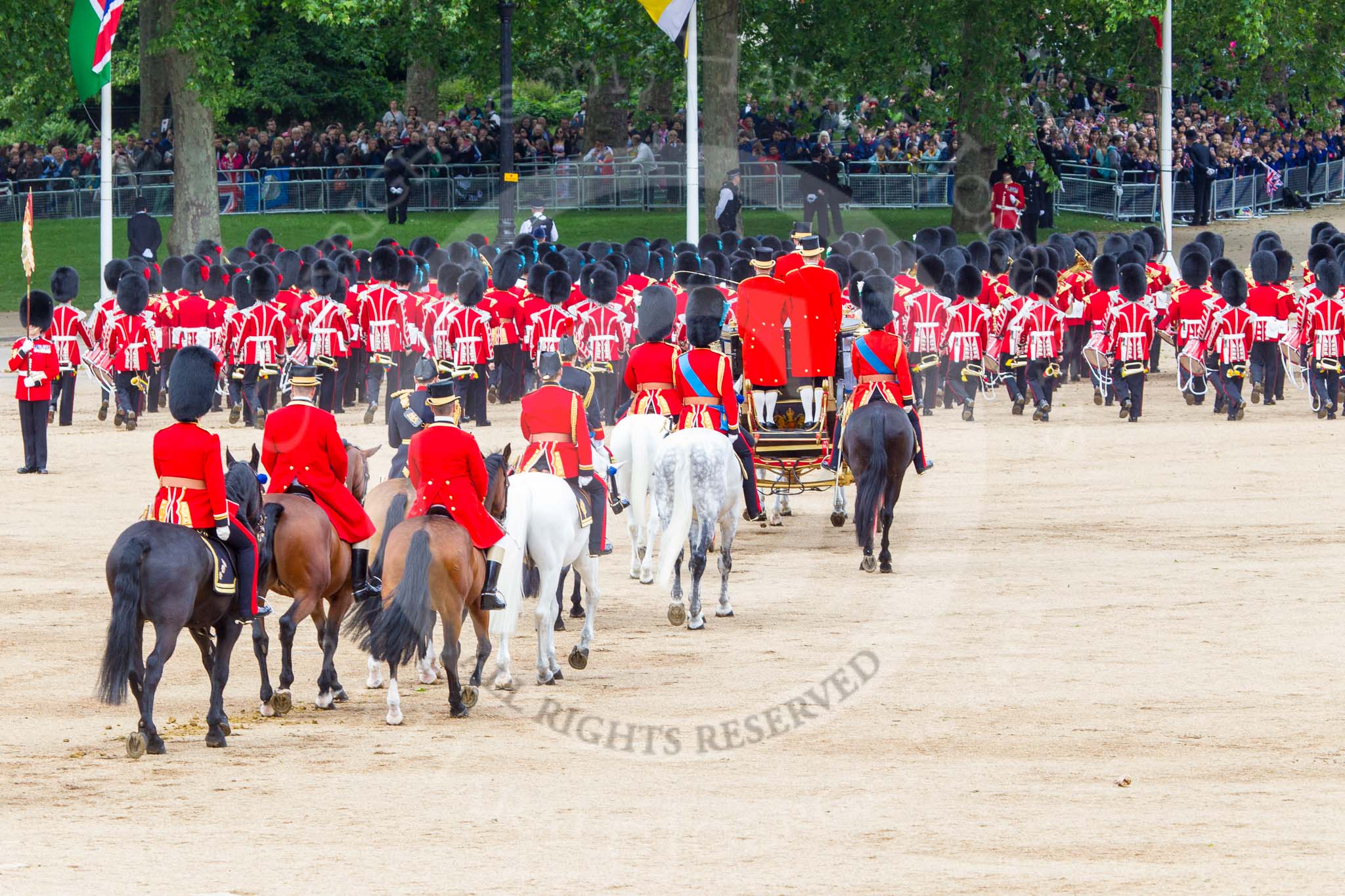 Trooping the Colour 2013: The March Off - the Massed Bands are leaving towards The Mall, followed by the glass coach carrying HM The Queen and HRH The Duke of Kent. Behind the glass coach the Royal Colonels. Image #834, 15 June 2013 12:11 Horse Guards Parade, London, UK