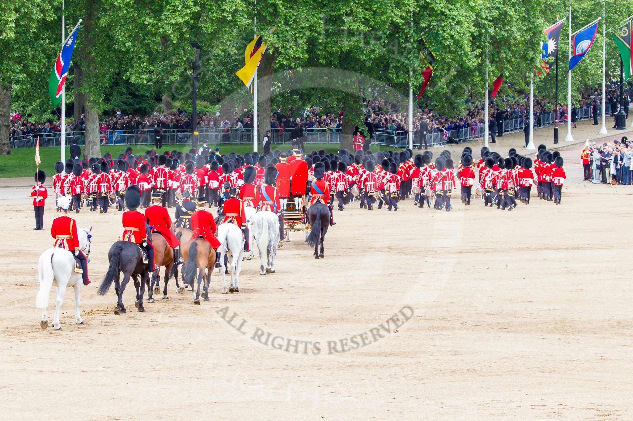 Trooping the Colour 2013: The March Off - the Massed Bands are leaving towards The Mall, followed by the glass coach carrying HM The Queen and HRH The Duke of Kent. Behind the glass coach the Royal Colonels. Image #835, 15 June 2013 12:12 Horse Guards Parade, London, UK