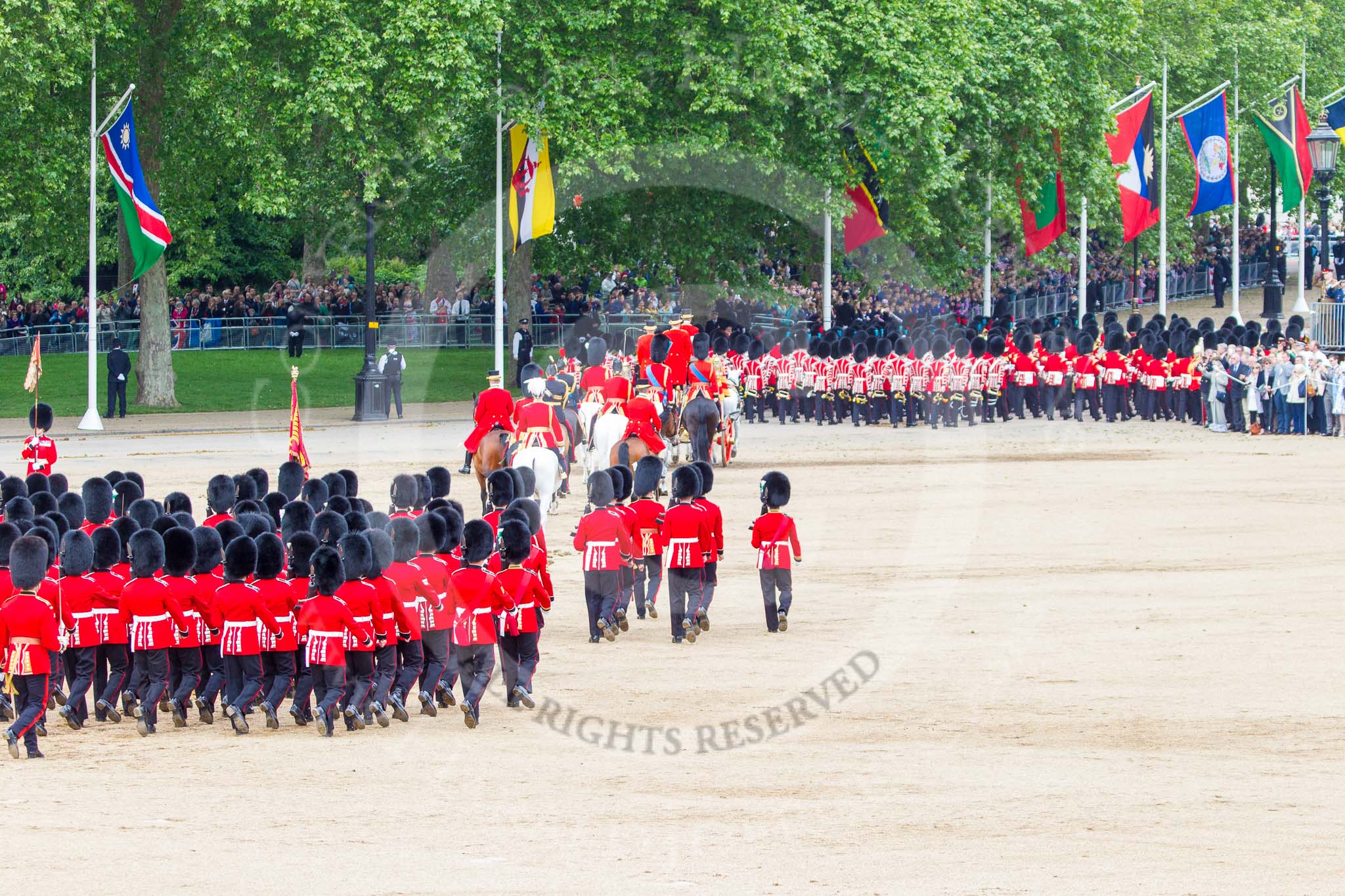 Trooping the Colour 2013: The March Off - the Massed Bands are leaving towards The Mall, followed by the glass coach carrying HM The Queen and HRH The Duke of Kent. Behind members of the Royal Procession, followed by No. 1 Guard, carrying the Colour. Image #845, 15 June 2013 12:12 Horse Guards Parade, London, UK
