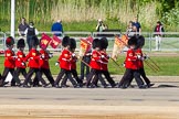 The 'Keepers of the Ground', guardsmen bearing marker flags for their respective regiments, marching on Horse Guards Road along St James's Park