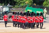 The 'Keepers of the Ground', guardsmen bearing marker flags for their respective regiments, marching towards Horse Guards Arch.