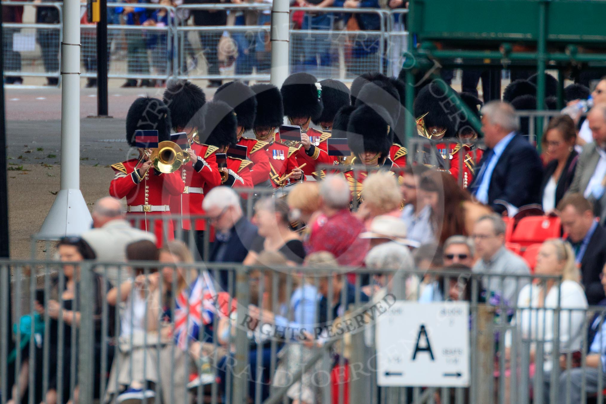 The Band of the Welsh Guards in the background, marching from The Mall to Horse Guards Parade during The Colonel's Review 2018 (final rehearsal for Trooping the Colour, The Queen's Birthday Parade)  at Horse Guards Parade, Westminster, London, 2 June 2018, 10:11.