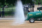 Major 1150 gallons water bowser spraying water onto the dusty surface before The Colonel's Review 2018 (final rehearsal for Trooping the Colour, The Queen's Birthday Parade)  at Horse Guards Parade, Westminster, London, 2 June 2018, 09:00.