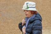 Female spectator, wearing a white hat with a large white rose in front, before The Colonel's Review 2018 (final rehearsal for Trooping the Colour, The Queen's Birthday Parade)  at Horse Guards Parade, Westminster, London, 2 June 2018, 09:07.