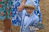 Young boy, wearing a striped three-piece-suit with a bow tie and a hat, holding a paper copy of the programme before The Colonel's Review 2018 (final rehearsal for Trooping the Colour, The Queen's Birthday Parade)  at Horse Guards Parade, Westminster, London, 2 June 2018, 09:13.