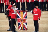 Duty Drummer  Sam Orchard saluting the uncased Colour held by Colour Sergeant Sam McAuley (31), with Colour Sentry Guardsman Jonathon Hughes (26) behind, during The Colonel's Review 2018 (final rehearsal for Trooping the Colour, The Queen's Birthday Parade)  at Horse Guards Parade, Westminster, London, 2 June 2018, 10:33.
