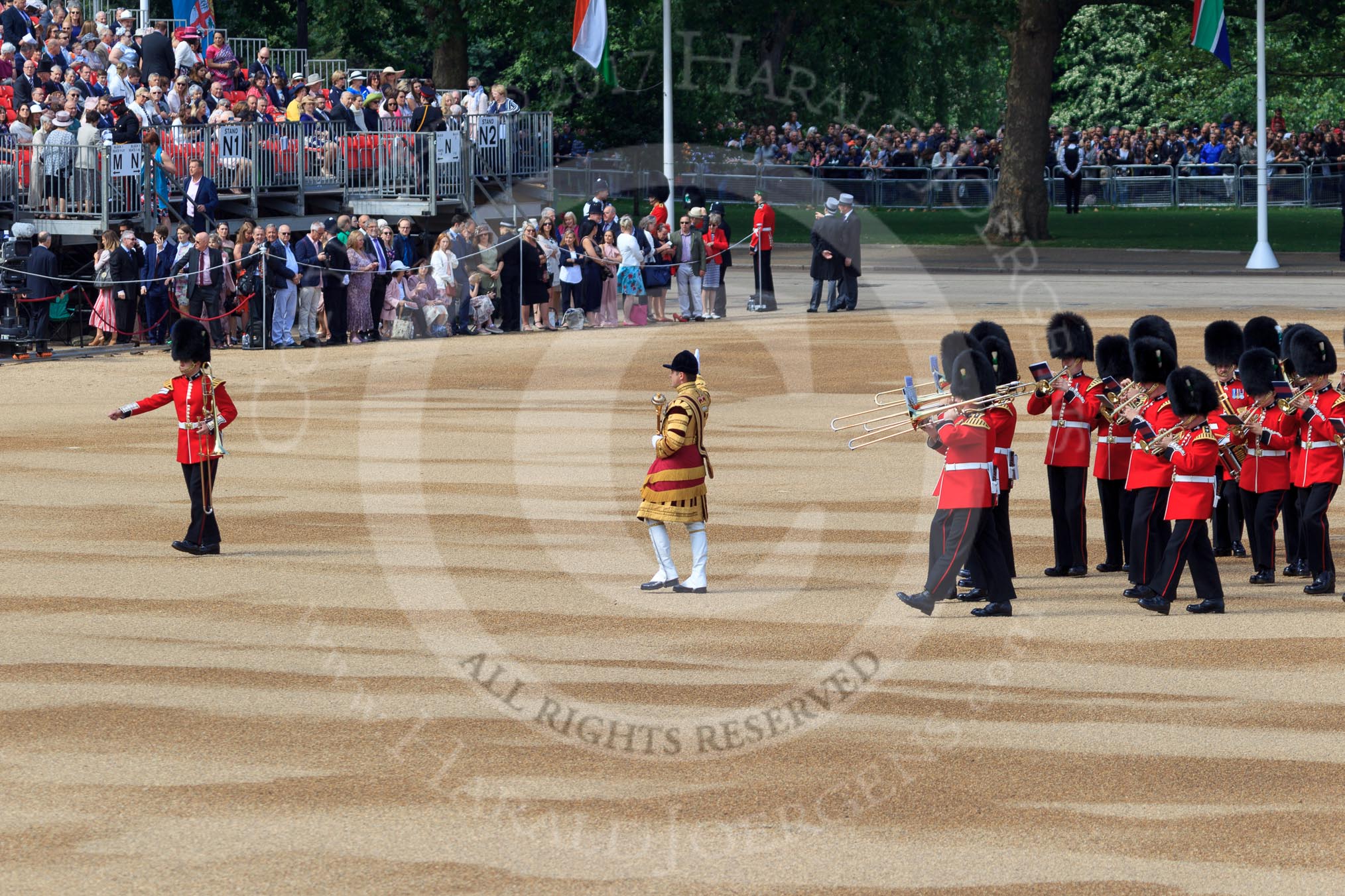 Senior Drum Major Damian Thomas, Grenadier Guards leading the Band of the Welsh Guards to their position on Horse Guards Parade (and the single musician marking the position moving out of the way) before Trooping the Colour 2018, The Queen's Birthday Parade at Horse Guards Parade, Westminster, London, 9 June 2018, 10:14.