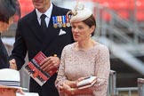 Royal Navy officer, wearing his medals and carrying an event programme, with his wife before Trooping the Colour 2018, The Queen's Birthday Parade at Horse Guards Parade, Westminster, London, 9 June 2018, 09:13.