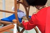 Garrison Sergeant Major (GSM) Headquarters London District, Warrant Officer Class 1 Andrew (Vern) Strokes placing an event programme on The Queen's seat before Trooping the Colour 2018, The Queen's Birthday Parade at Horse Guards Parade, Westminster, London, 9 June 2018, 10:00.