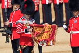 The Duty Drummer Sam Orchard has removed the case from the Colour held by the Colour Sergeant Sam McAuley (31) whilst Colour Sentry Guardsman Jonathon Hughes (26) salutes during Trooping the Colour 2018, The Queen's Birthday Parade at Horse Guards Parade, Westminster, London, 9 June 2018, 10:33.