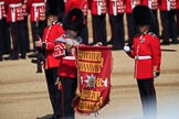 The Duty Drummer Sam Orchard has removed the case from the Colour held by the Colour Sergeant Sam McAuley (31) whilst Colour Sentry Guardsman Jonathon Hughes (26) salutes during Trooping the Colour 2018, The Queen's Birthday Parade at Horse Guards Parade, Westminster, London, 9 June 2018, 10:33.