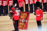 The Duty Drummer Sam Orchard salutes the Colour after removing the case from the Colour held by the Colour Sergeant Sam McAuley (31) during Trooping the Colour 2018, The Queen's Birthday Parade at Horse Guards Parade, Westminster, London, 9 June 2018, 10:33.