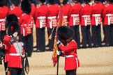 The Duty Drummer Sam Orchard salutes the Colour after removing the case from the Colour held by the Colour Sergeant Sam McAuley (31)  during Trooping the Colour 2018, The Queen's Birthday Parade at Horse Guards Parade, Westminster, London, 9 June 2018, 10:33.